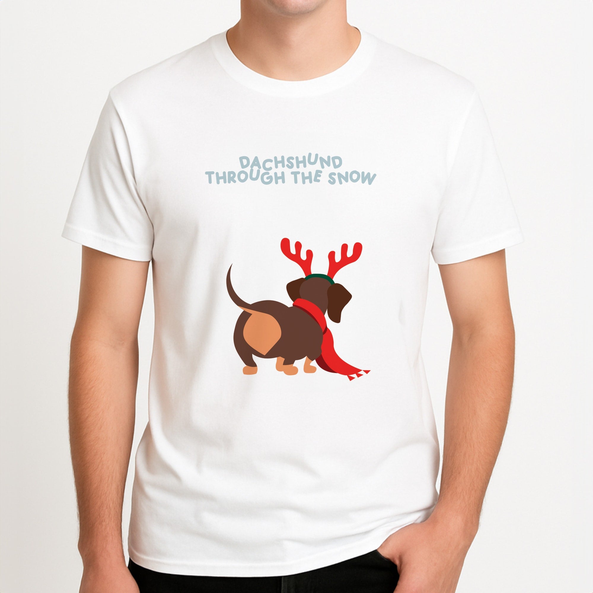 Dachshund Through The Snow - Christmas Unisex T-Shirt, worn by a male model.